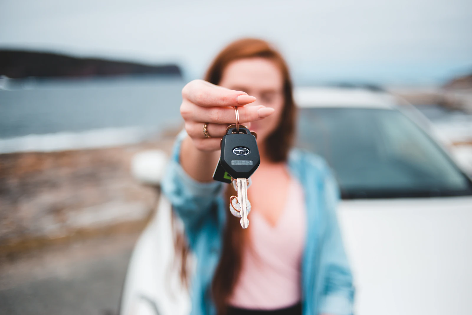 A customer receiving car keys at the Halcyon Motors showroom